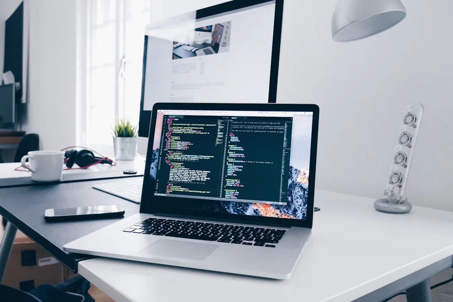 Software engineer working at a technical dual-monitor workstation